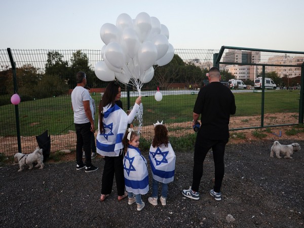 People wait for arrival of vehicle carrying hostages at Schneider Children's Medical Center in Israel's Petah Tikva (Image Credit: Reuters)