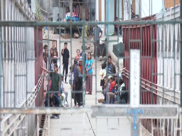 Chin refugees await opening of the gates on the bride over River Tiau to cross over to India (Photo/ANI)