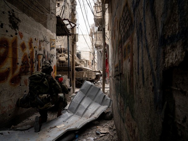 An Israeli soldier takes position during the ongoing ground operation by the Israeli army, in a location given as Gaza (Photo Credit: Reuters)